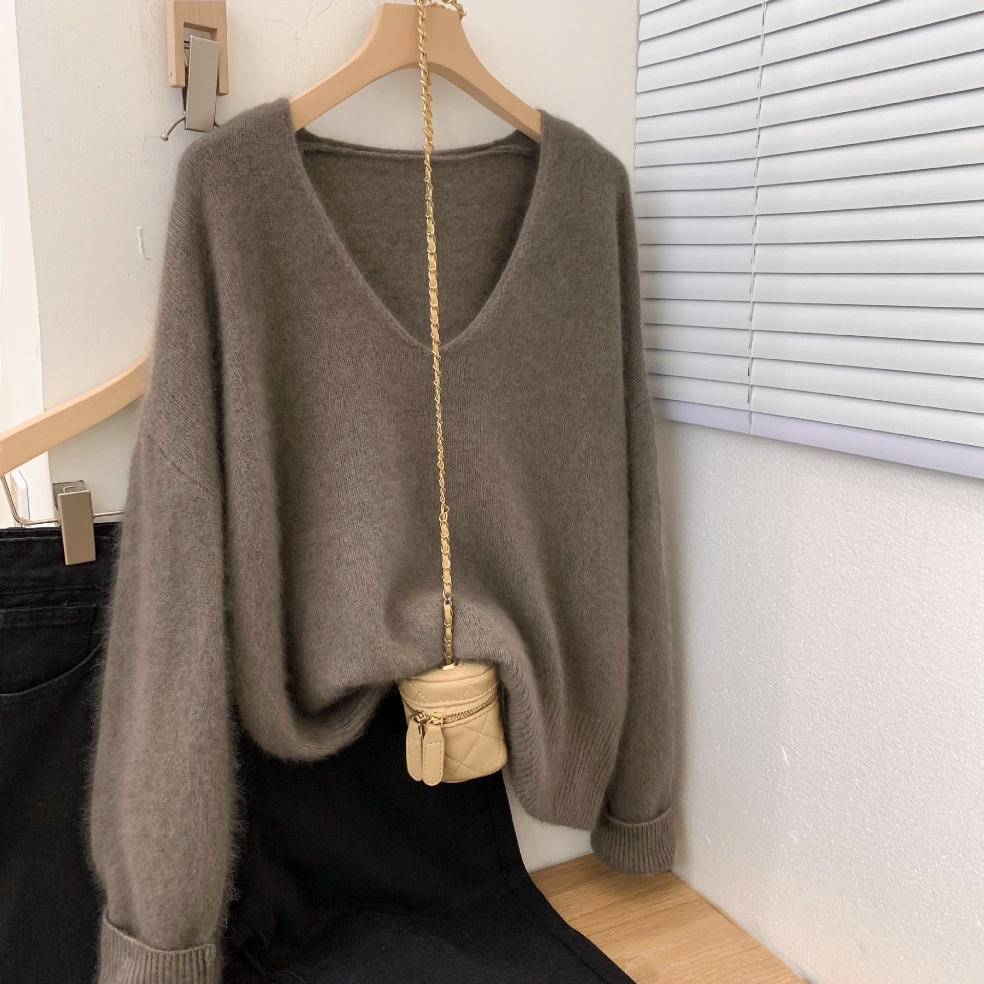 Women's loose fit v-neck pullover sweater with crochet lace trim at the neckline and hem, elegant long-sleeve knit top