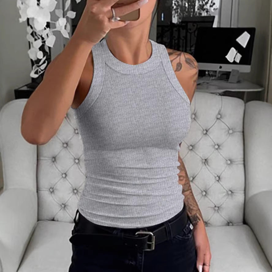 Women's slim-fit sleeveless ribbed knit vest top in a neutral tone, shown from the front on a model.
