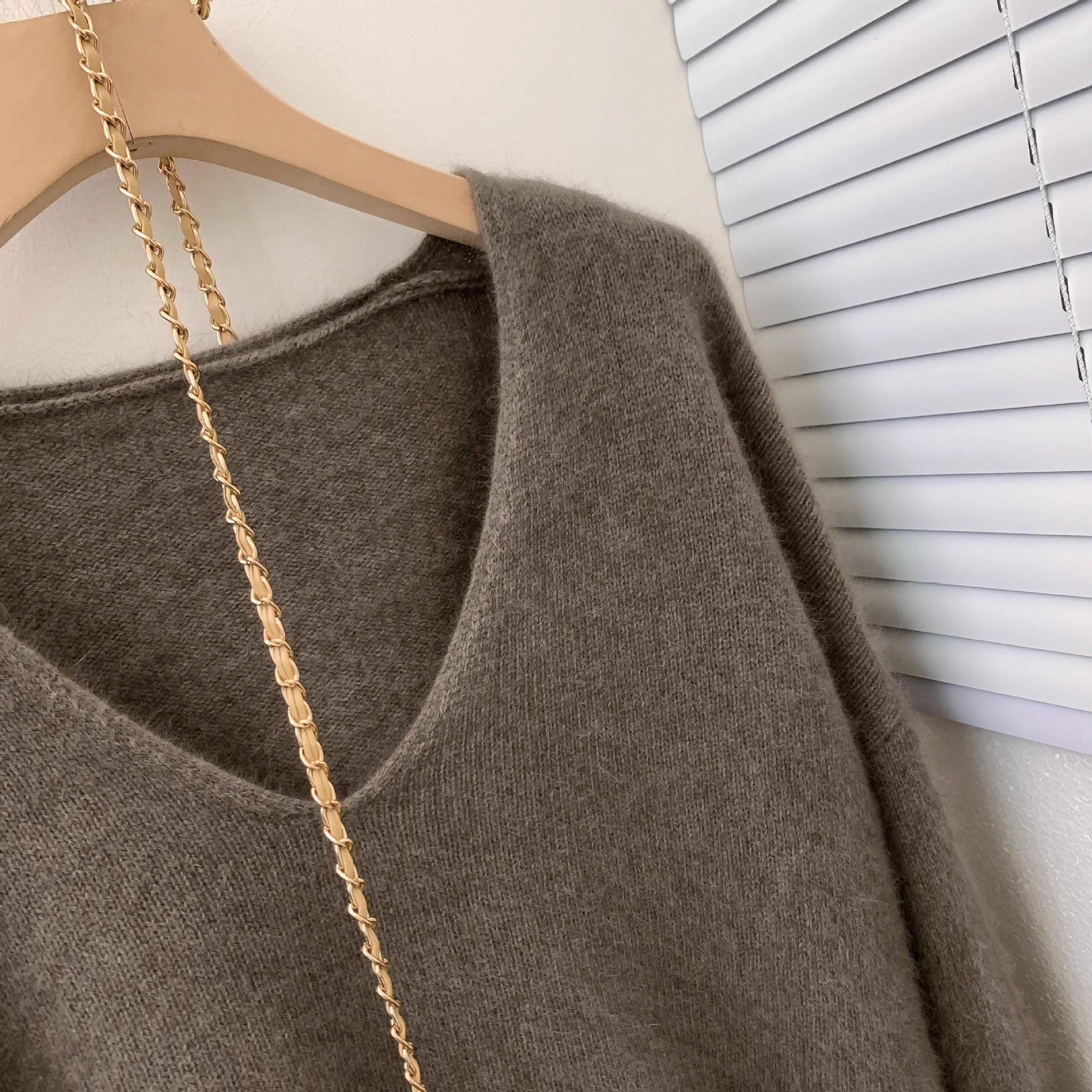 Women's loose fit V-neck pullover sweater featuring delicate crochet lace trim and long sleeves, elegant knit top