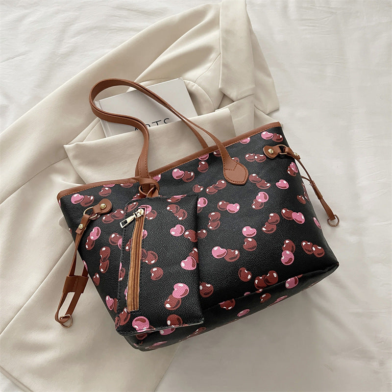 Large capacity women's tote bag with underarm strap shown from a side angle, highlighting its spacious structured design