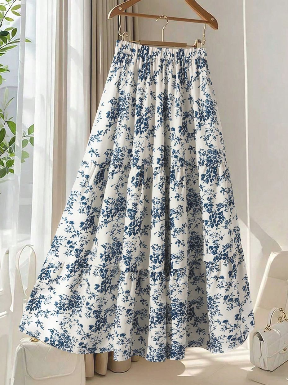 Women's high-waisted floral print midi skirt with a flared A-line silhouette, shown in a close-up detail view
