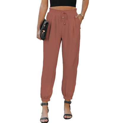 Women's high waist flared trousers with side pockets, shown in a close-up detail view highlighting the wide-leg silhouette.