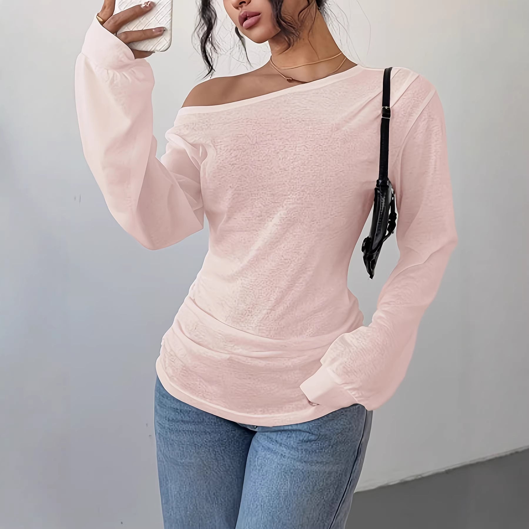 Women's one-shoulder long sleeve top in a solid color with a slash neckline and relaxed loose fit silhouette
