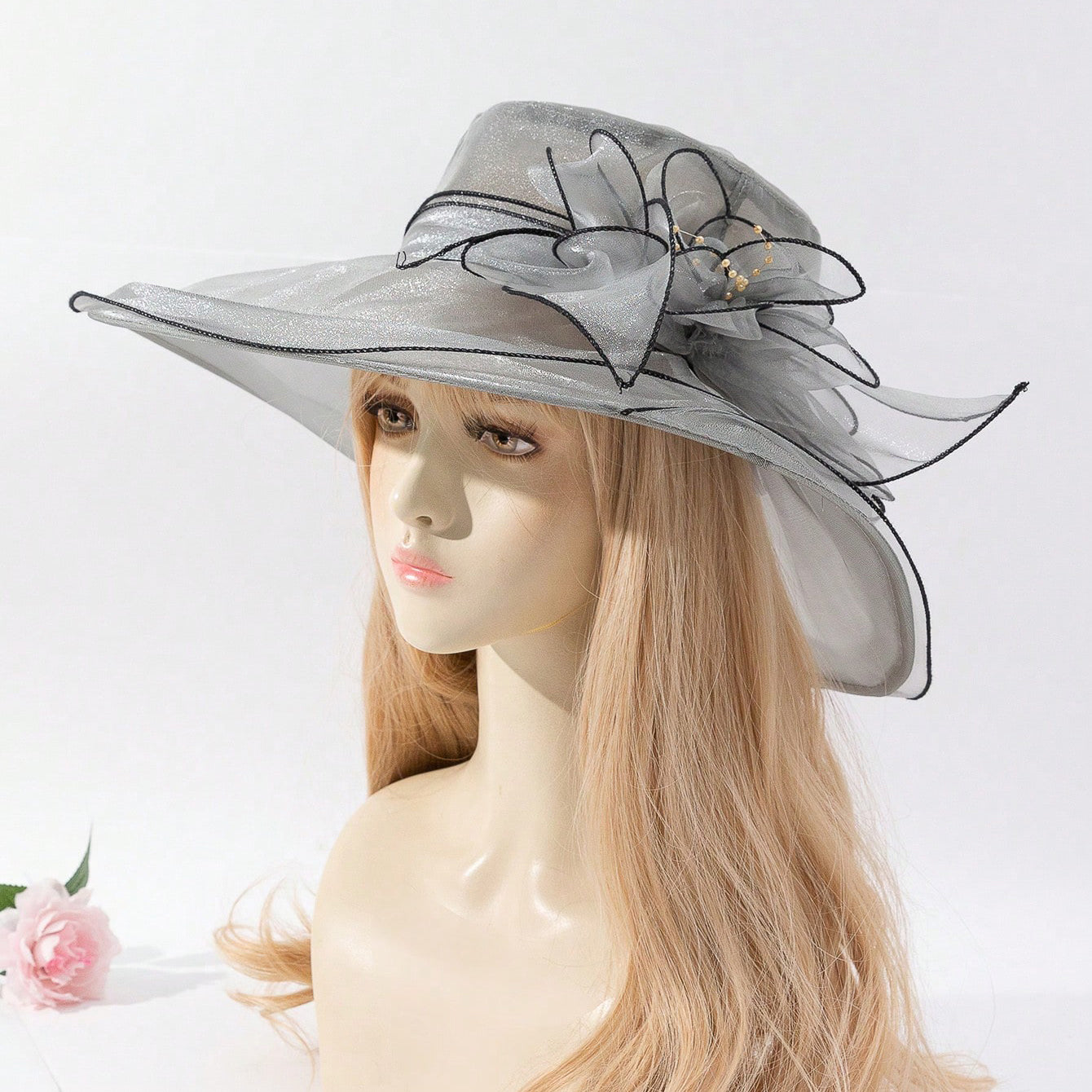 Soft chiffon fisherman hat with delicate flower accent, shown from a side angle highlighting the elegant brim and floral deta