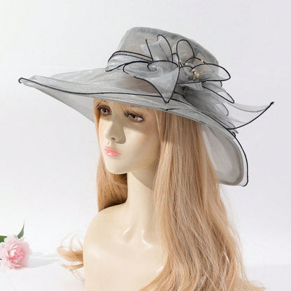 Soft chiffon fisherman hat with delicate flower accent, shown from a side angle highlighting the elegant brim and floral deta