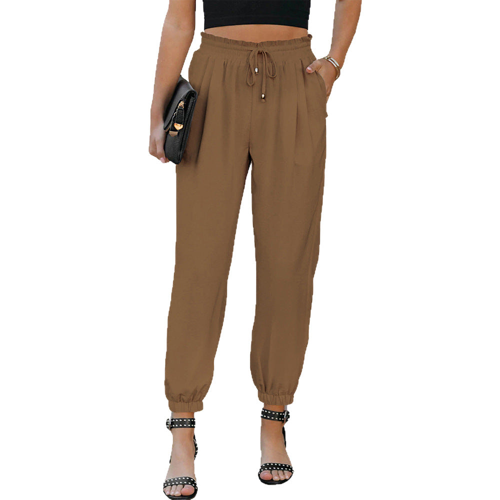 Women's high waist flared trousers with side pockets shown in a close-up detail view highlighting the waistband and flared le