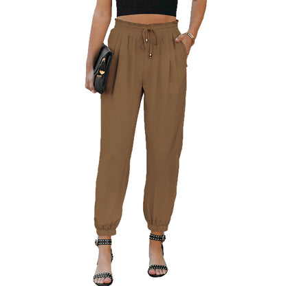 Women's high waist flared trousers with side pockets shown in a close-up detail view highlighting the waistband and flared le