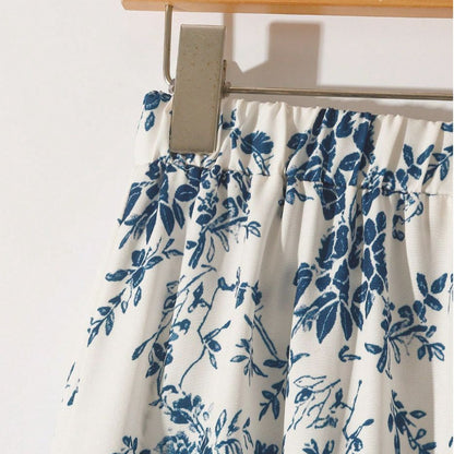 Women's high-waisted floral midi skirt with a flared A-line silhouette, shown in a close-up detail view of the print.
