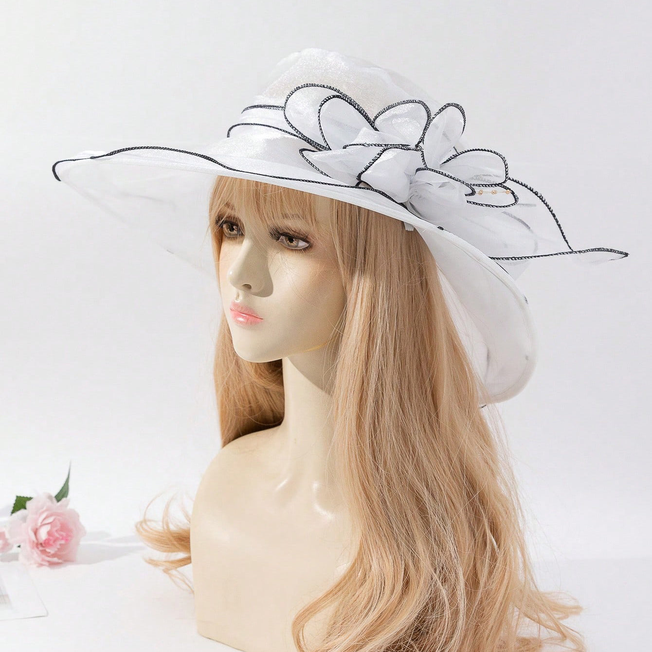 Women's chiffon fisherman hat with delicate flower accent, shown as a stylish sun-protective cap for beach and outdoor wear
