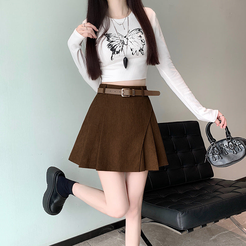 Women's corduroy mini skort with high waist and pleated front detail, shown in a close-up view highlighting the fabric textur