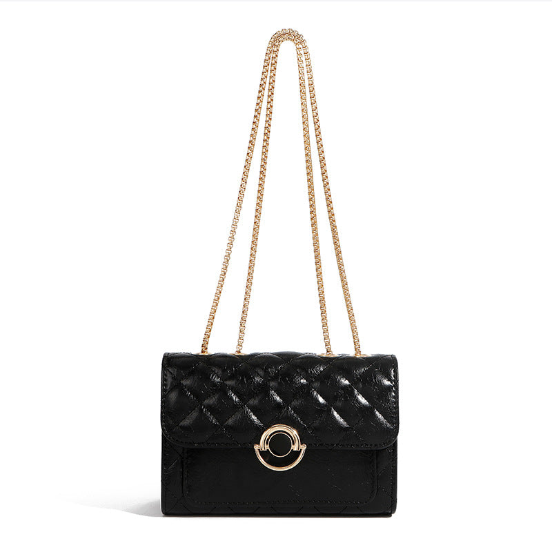Minimalist PU crossbody bag with gold chain strap, shown in a neutral tone with clean structured silhouette