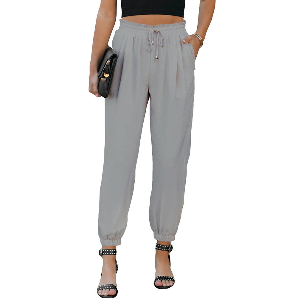 Women's high waist flared trousers with side pockets, shown in a relaxed flat lay style