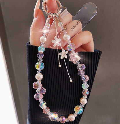 Crystal beaded phone lanyard bracelet with card holder and tassel charm, worn as a wrist strap accessory