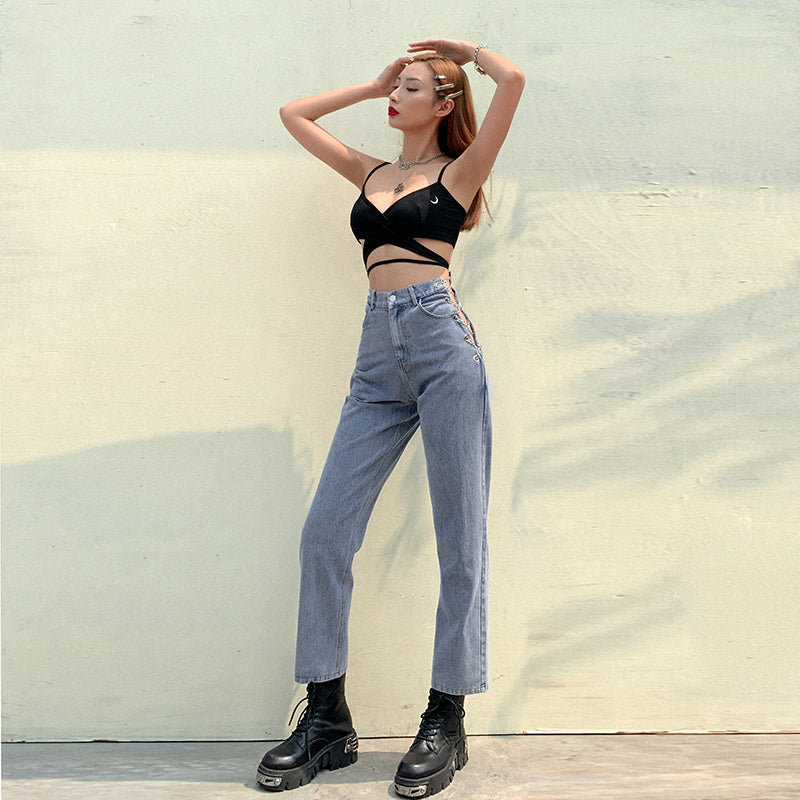 Women's high waist straight leg jeans with silver chain detail at the waist, shown from a side angle