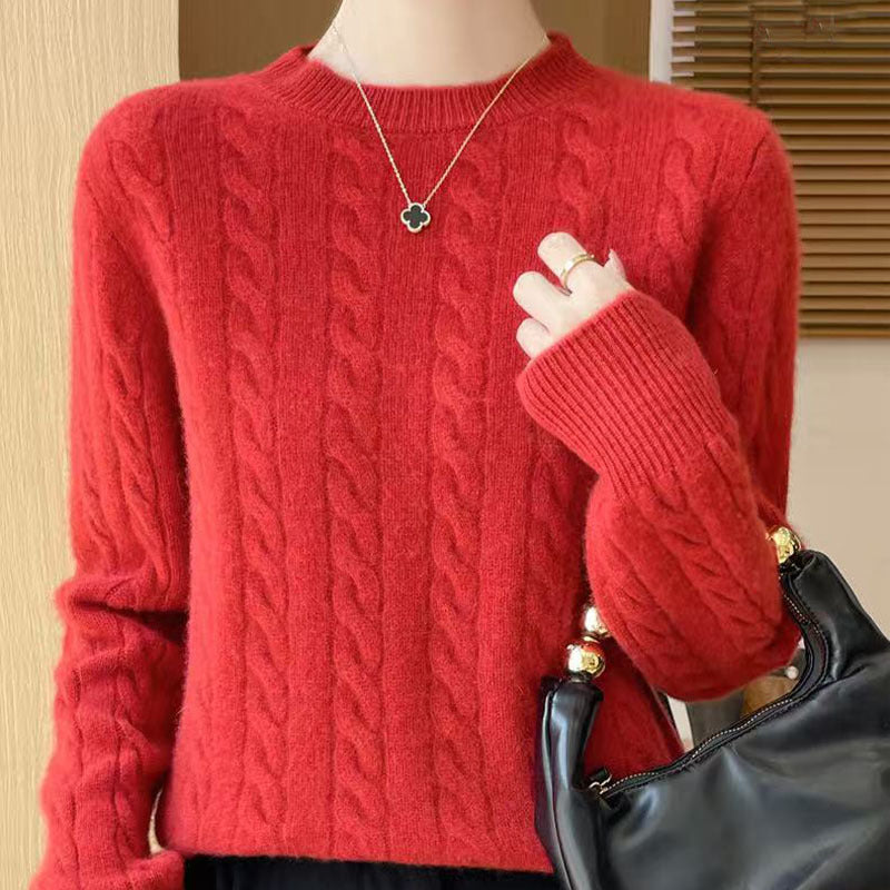 Women's loose cable-knit crewneck sweater in merino wool blend, shown from the back highlighting the textured knit pattern.