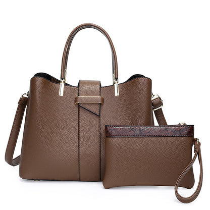 Retro bucket handbag with detachable crossbody strap shown from a close-up angle highlighting stitching and hardware details