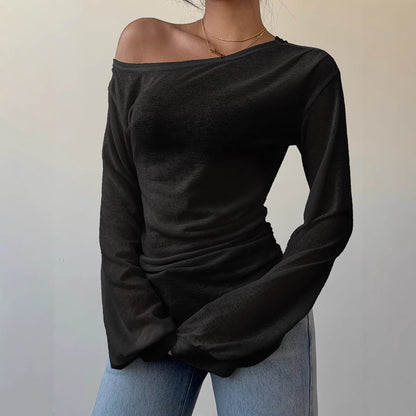 Women's one-shoulder long sleeve top laid flat, showing relaxed loose fit and slash neckline in a solid neutral color