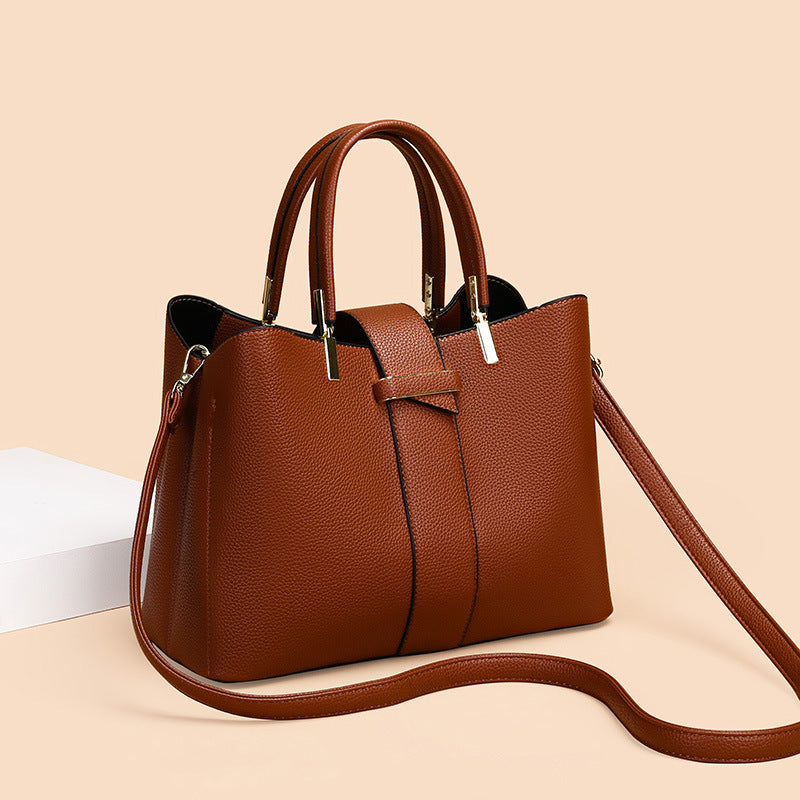 Retro bucket handbag with removable crossbody strap shown from the side, highlighting its structured silhouette and vintage-i