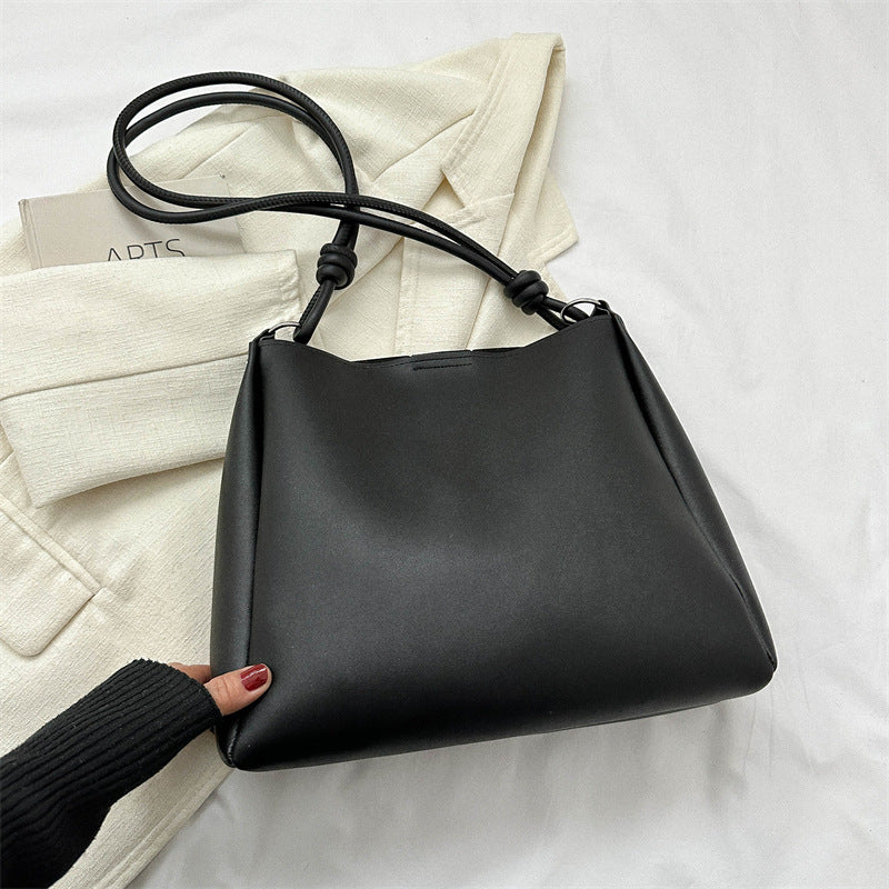Women's PU leather retro bucket crossbody tote bag in a structured silhouette, shown as a stylish commuter purse