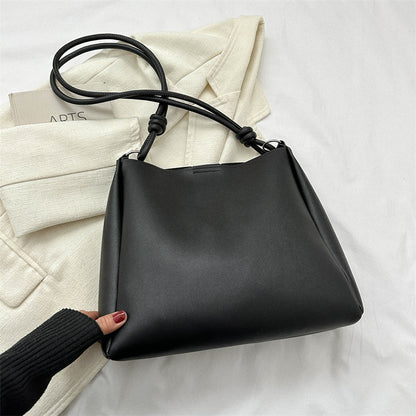 Women's PU leather retro bucket crossbody tote bag in a structured silhouette, shown as a stylish commuter purse