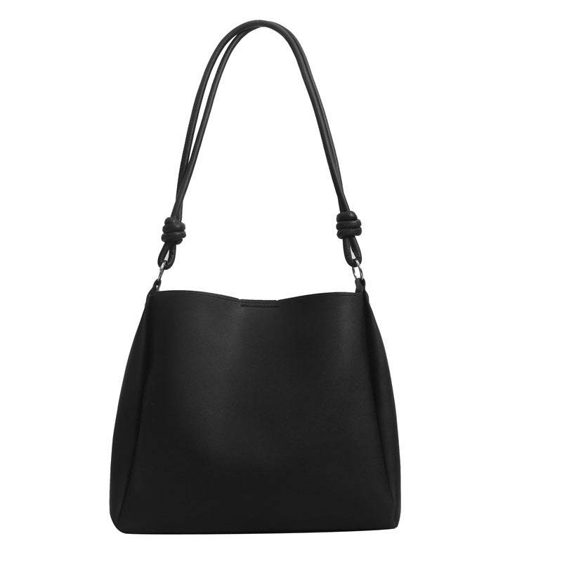 Women's PU leather retro bucket crossbody tote bag in a neutral tone, shown as a stylish commuter purse with adjustable strap
