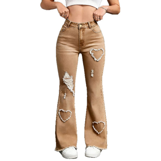 Women's high waist flared denim jeans featuring embroidery and ripped details, shown from a side angle