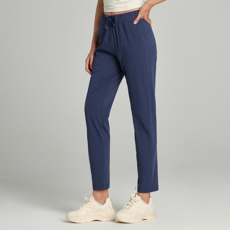 Women's loose straight-leg cropped pants with a drawstring waist, shown in a relaxed casual style