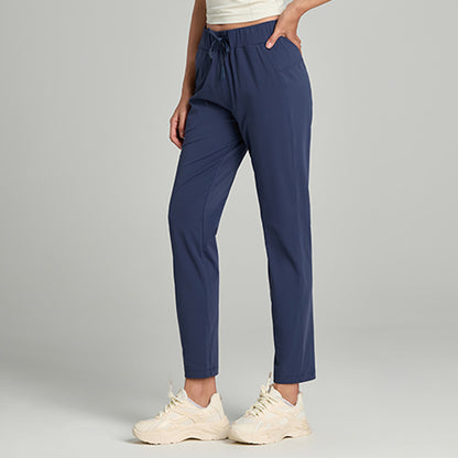 Women's loose straight-leg cropped pants with a drawstring waist, shown in a relaxed casual style