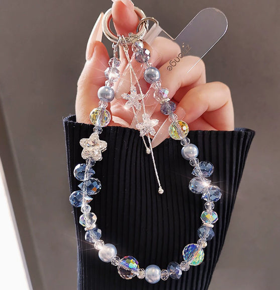 Crystal beaded phone lanyard bracelet with card holder and tassel charm, worn as a wrist strap accessory