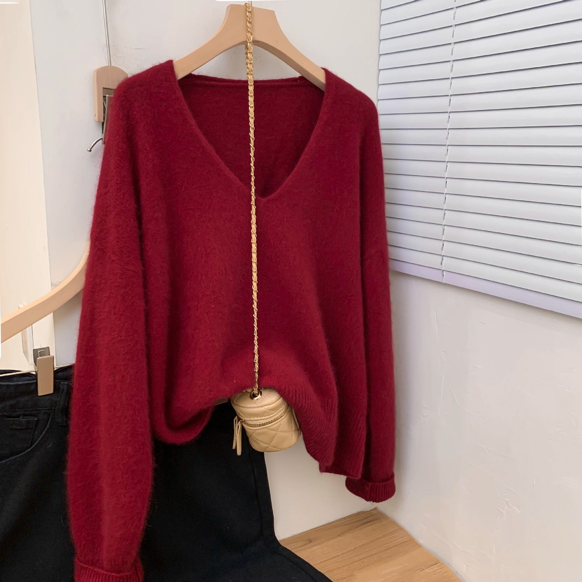 Women's loose fit V-neck pullover sweater with delicate crochet lace trim, shown in a relaxed long-sleeve knit style