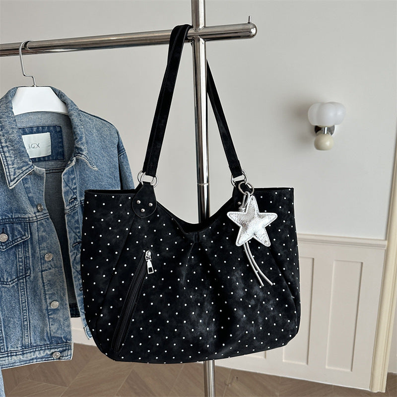 Spacious canvas tote shoulder bag for women shown from the side, highlighting roomy interior and sturdy handles