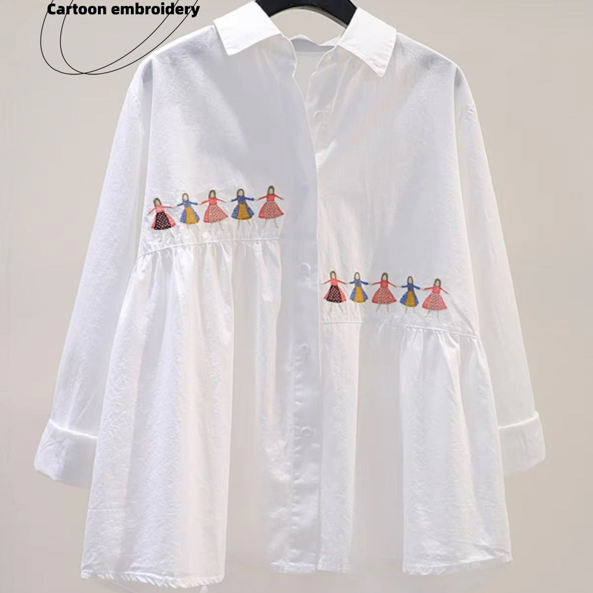 White loose fit cotton blouse with playful embroidered cartoon detail, relaxed silhouette in crisp white fabric