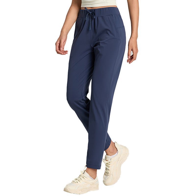 Women's loose straight-leg cropped pants with an elastic drawstring waist, shown in a relaxed casual style