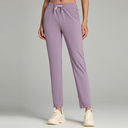 Women's loose straight-leg cropped pants with an elastic drawstring waist, shown in a relaxed casual style