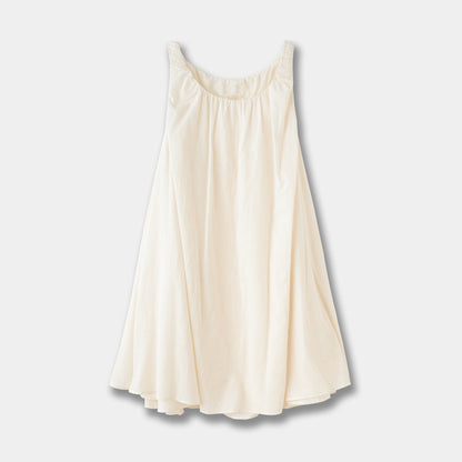 Sleeveless pleated suspender midi dress in beige cotton showing back strap detail and flowing skirt in mori style