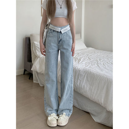 Women's high waist wide leg jeans with a folded waistband, shown in a relaxed denim style from a side angle.
