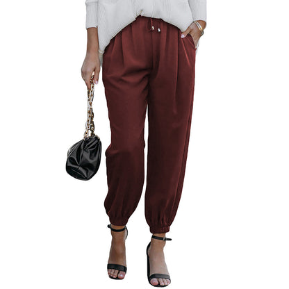 Women's high waist flared trousers with side pockets shown in a close-up detail view highlighting the wide-leg silhouette