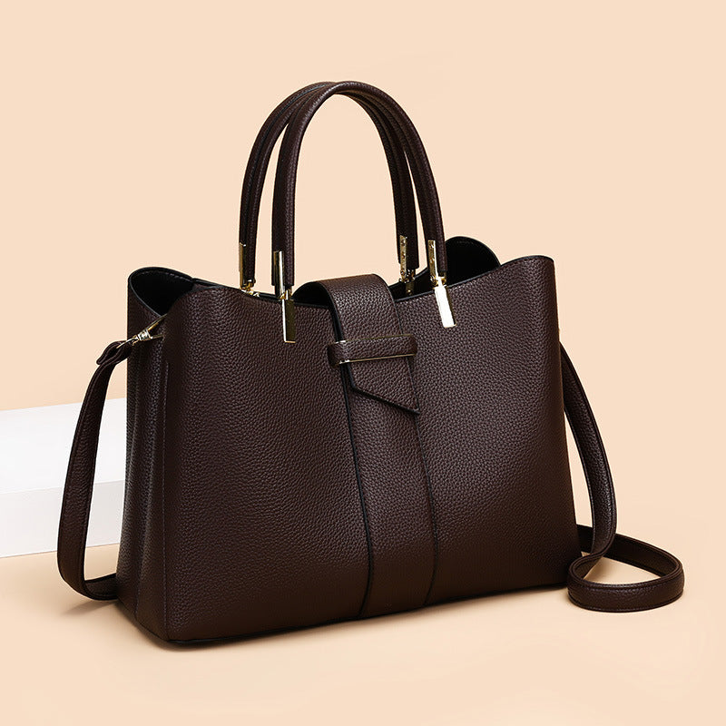 Retro women's bucket handbag with adjustable crossbody strap, shown in a close-up detail view highlighting the bag's texture 