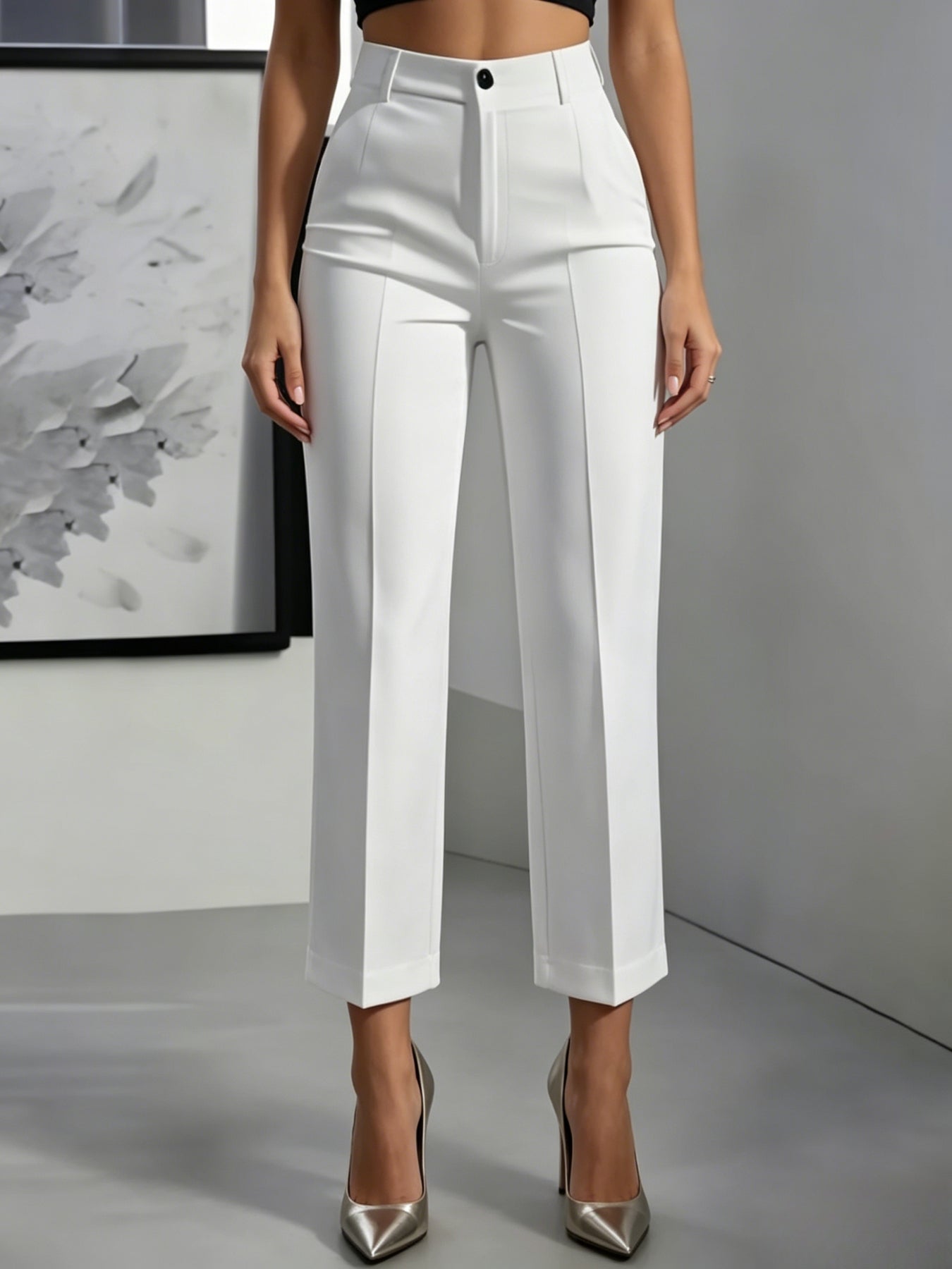 Women's high-waisted straight-leg cropped trousers shown from the side, highlighting the tailored fit and cropped hem length.
